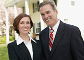 Two business professionals standing outside an office
